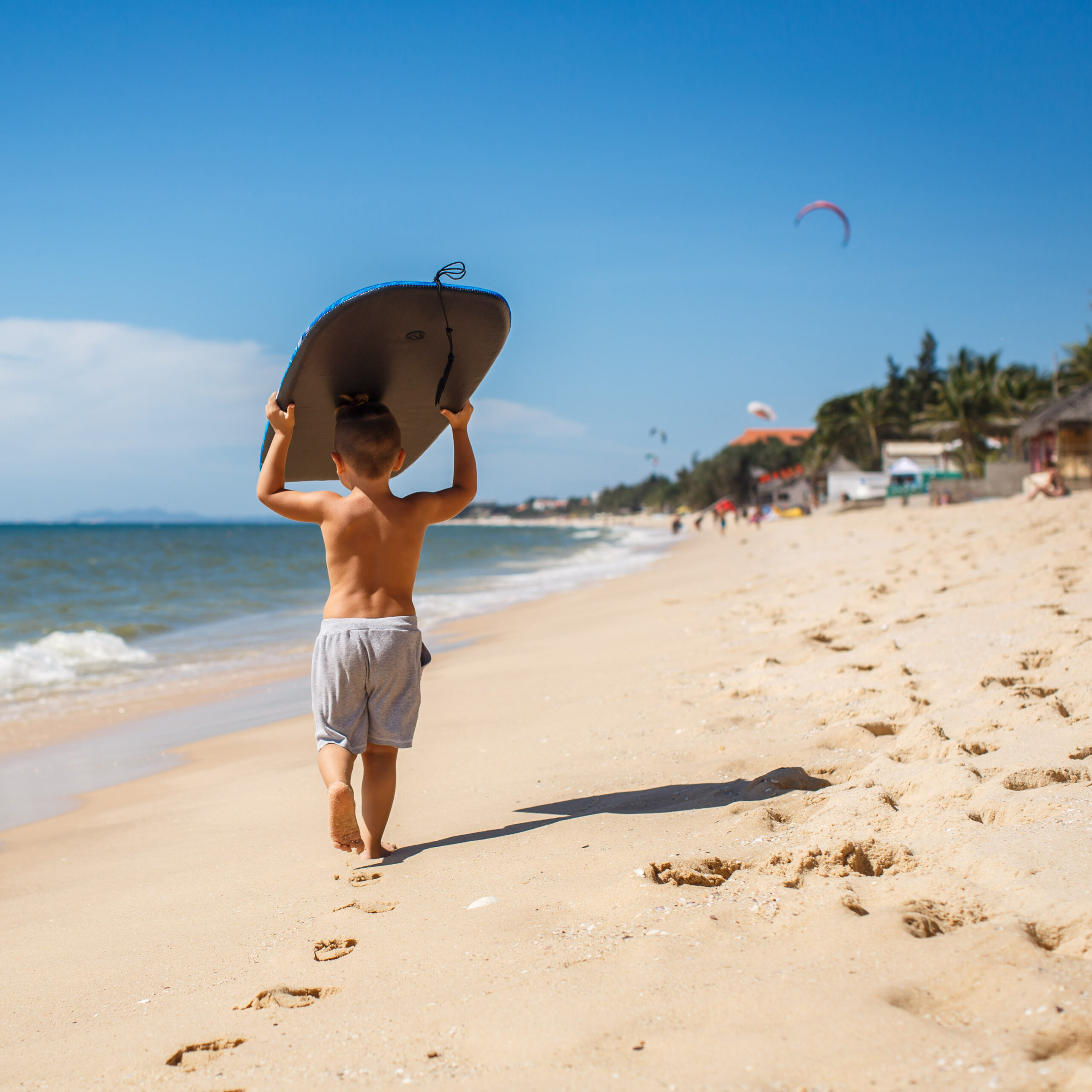 4 year old boy with a surfboard